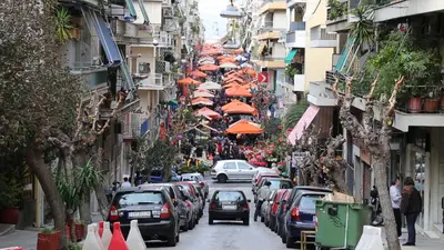 a city street with cars parked on the side of the road at Studio with sunny balcony in Exarcheia in Athens