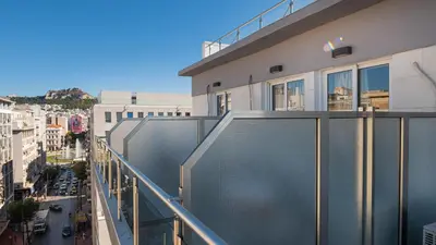 a balcony of a building with a view of a city at Diros Hotel in Athens