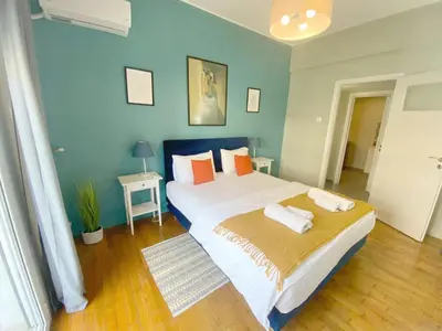 a bedroom with a large bed with two towels on it at Check Point - Syngrou Fix in Athens
