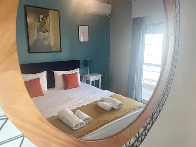 a bedroom with a bed in a mirror at Check Point - Syngrou Fix in Athens