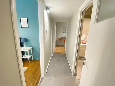 a hallway leading to a kitchen with blue walls at Check Point - Syngrou Fix in Athens