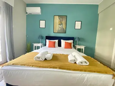 a bedroom with a large bed with two towels on it at Check Point - Syngrou Fix in Athens