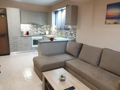 a living room with a couch and a table at Vaso's country house near the beach and airport in Porto Rafti