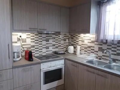 a kitchen with a sink and a stove top oven at Vaso's country house near the beach and airport in Porto Rafti