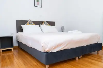 a bedroom with a large bed with white sheets at Aristotelous Lux Apartment In Athens VIPGreece in Athens