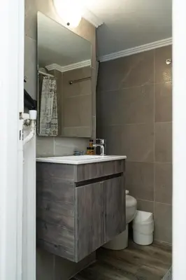 a bathroom with a sink and a mirror and a toilet at Aristotelous Lux Apartment In Athens VIPGreece in Athens