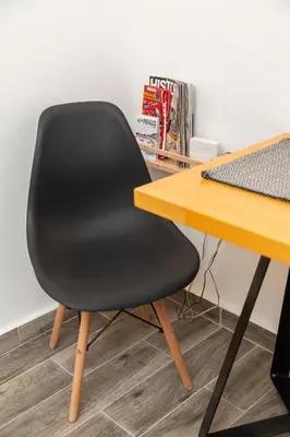 a black chair sitting next to a desk at Aristotelous Lux Apartment In Athens VIPGreece in Athens