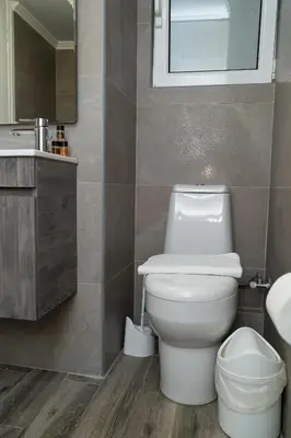 a bathroom with a white toilet and a sink at Aristotelous Lux Apartment In Athens VIPGreece in Athens
