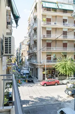 a red car parked in front of a building at Aristotelous Lux Apartment In Athens VIPGreece in Athens