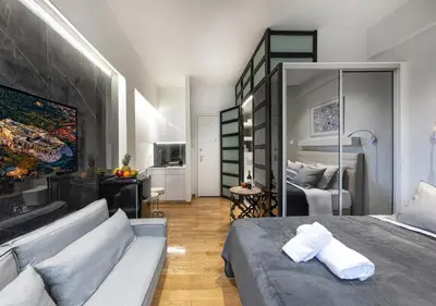 a bedroom with a bed and a living room at The Monastiraki Metro Lux Suite! in Athens