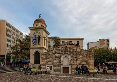 a church with a clock tower in a city at The Monastiraki Metro Lux Suite! in Athens