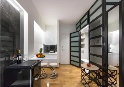 a kitchen with a table and two stools in a room at The Monastiraki Metro Lux Suite! in Athens