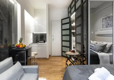 a room with two beds and a kitchen in it at The Monastiraki Metro Lux Suite! in Athens