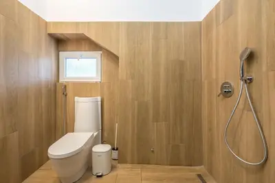 a bathroom with a toilet and a shower at Garden Villa Glyfada in Athens