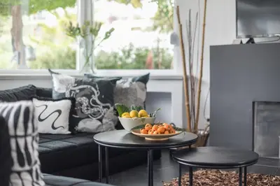 a living room with a bowl of fruit on a table at Garden Villa Glyfada in Athens