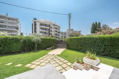 a garden with a building in the background at Garden Villa Glyfada in Athens