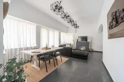a living room with a table and a couch at Garden Villa Glyfada in Athens