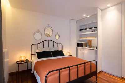 a bedroom with a large bed and a kitchen at Phaedrus Living: City Centre Luxury Flat Mavromichali in Athens
