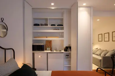 a room with a kitchen and a living room at Phaedrus Living: City Centre Luxury Flat Mavromichali in Athens