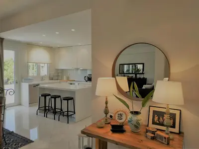 a kitchen with a table with a mirror and a counter at Luxury Garden Apartment Glyfada in Athens