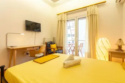 a bedroom with a yellow bed and a window at Athens Perfect Spot - Zografou Cozy Home in Athens
