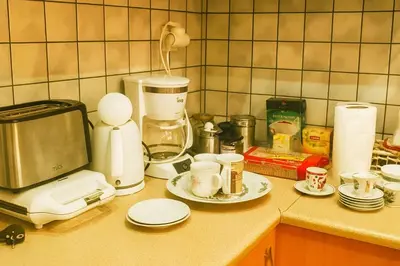 a kitchen counter with a coffee maker and cups at Athens Perfect Spot - Zografou Cozy Home in Athens