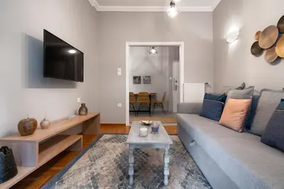 a living room with a couch and a flat screen tv at Absolute Athens X in Athens