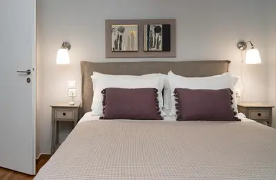 a bedroom with a large bed with two pillows at Absolute Athens X in Athens