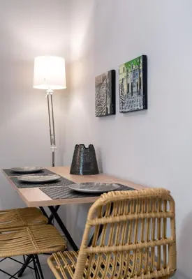 a desk with a chair and a table with a lamp at Absolute Athens X in Athens