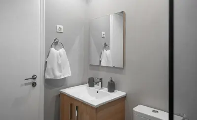 a bathroom with a sink and a mirror at Absolute Athens X in Athens