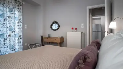 a bedroom with a bed and a clock on the wall at Absolute Athens X in Athens