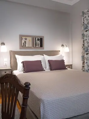 a bedroom with a large bed with purple pillows at Absolute Athens X in Athens