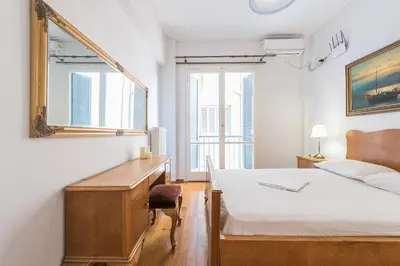 a bedroom with a bed and a desk and a mirror at Victoria Plaza Palace Apartments in Athens