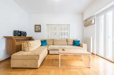 a living room with a couch and a table at Victoria Plaza Palace Apartments in Athens