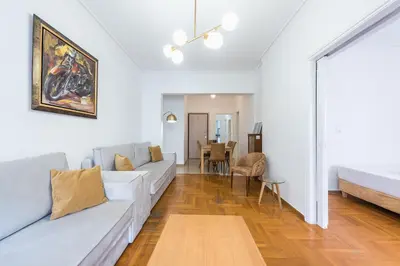 a living room with a couch and a table at Victoria Queens Suites Apartments in Athens