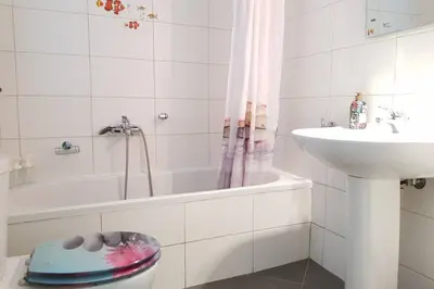 a bathroom with a sink and a toilet and a tub at A Great Stay at a Comfortable Large Apartment in Athens