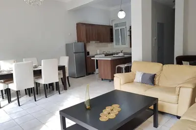 a living room with a couch and a table at A Great Stay at a Comfortable Large Apartment in Athens