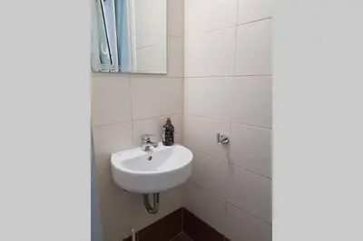a bathroom with a sink and a mirror at A Great Stay at a Comfortable Large Apartment in Athens