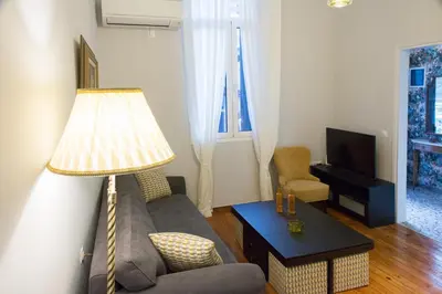 a living room with a couch and a lamp at Vol.3 in Athens