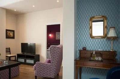 a living room with a chair and a mirror at Vol.3 in Athens
