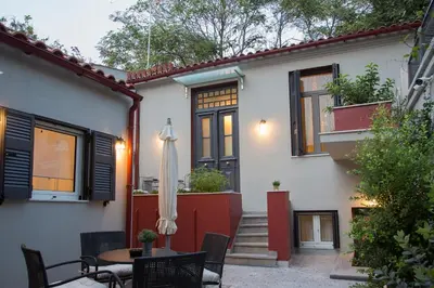 a house with a patio with a table and an umbrella at Vol.3 in Athens