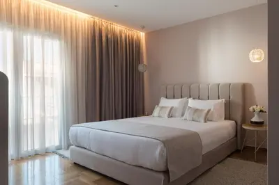 a bedroom with a large bed and a large window at Acropolis View Penthouse in Athens