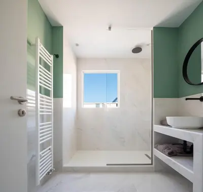 a bathroom with green and white walls and a shower at Acropolis View Penthouse in Athens