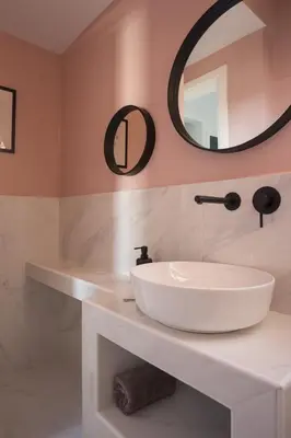 a bathroom with a white sink and a mirror at Acropolis View Penthouse in Athens
