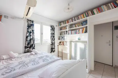 a bedroom with a bed and bookshelves at Amazing Acropolis View from Exarcheia in Athens