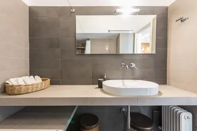 a bathroom with a sink and a mirror at Amazing Acropolis View from Exarcheia in Athens