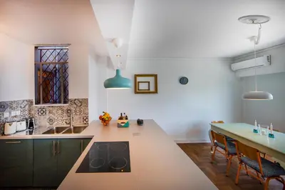 a kitchen with a counter and a table with chairs at Amazing Penthouse in Athens city center in Athens