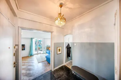 a hallway with a mirror and a chandelier at Amazing Penthouse in Athens city center in Athens