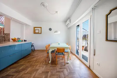 a kitchen and dining room with a table and chairs at Amazing Penthouse in Athens city center in Athens