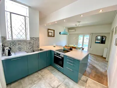 a kitchen with blue cabinets and a sink at Amazing Penthouse in Athens city center in Athens